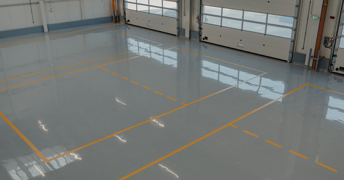 Epoxy flooring in warehouse with garage doors.
